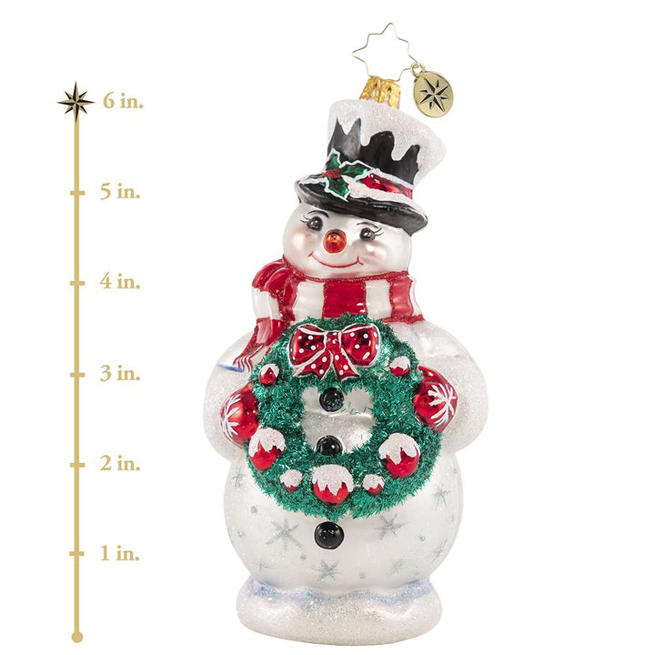 Ornament Description - Darling Christmas Decorator: Deck the halls! Wreath in hand, this sweet snowman is always first to volunteer for holiday decorating duty. This photo shows the ornament is about 6 inches tall. 