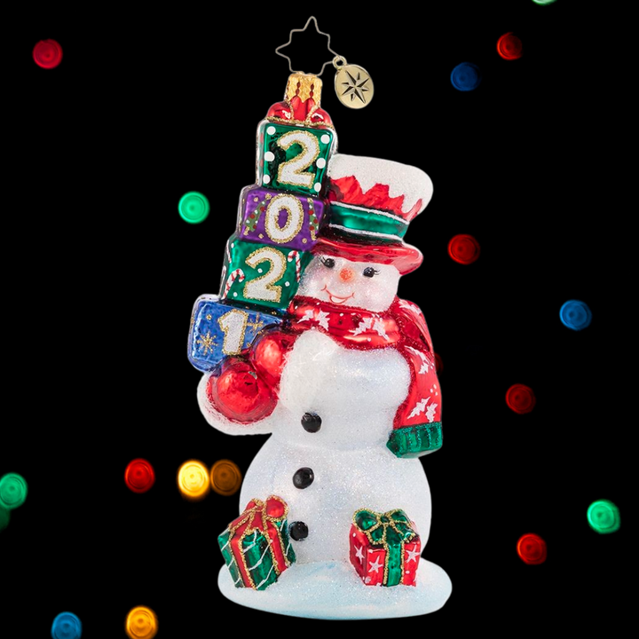 Ornament Description - 2021 Teetering Tower of Treasures - His shopping is done and his presents are festively wrapped. Mr. Snowman is ready for any and every celebration of the 2021 Christmas season!