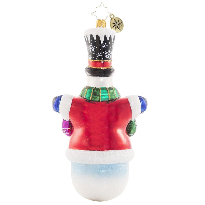 Back - Ornament Description - Crochet All Day!: Who knew you could knit with mittens on? Frosty has been hard at work making cozy gifts for his loved ones! This special ornament has been hand-picked by the Radko team to be part of the Limited Edition collection.
