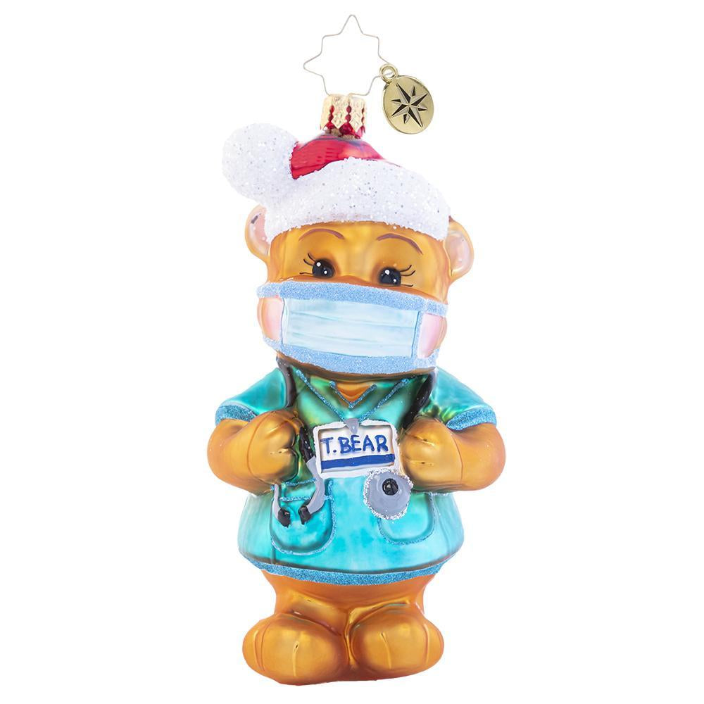 Front - Ornament Description - Dr. Ted E. Bear: Paging Dr. Ted E. Bear! Putting smiles on faces all day long, there is nothing he could ever do wrong!Â  A portion of the proceeds from the sale of this ornament will be donated to an organization providing relief for the COVID-19 Pandemic.