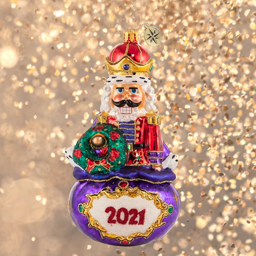 Ornament Description - Imperial Icon Nutcracker 2021: Ever the dutiful servant, this noble nutcracker watches over Santa's sack of treasures. He takes his job seriously, but he cannot help 'cracking' a smile!