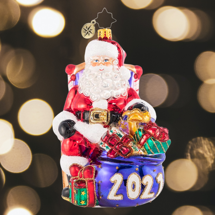 Ornament Description - Kick Back And Relax 2021: The presents have all been delivered and the reindeer are fast asleep in their stalls. Now Santa can finally relax and reflect, which he does best from his biggest, comfiest chair!