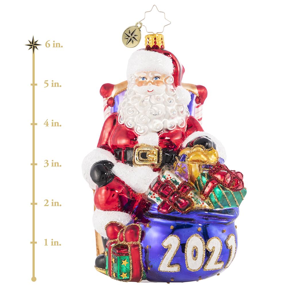 Ornament Description - Kick Back And Relax 2021: The presents have all been delivered and the reindeer are fast asleep in their stalls. Now Santa can finally relax and reflect, which he does best from his biggest, comfiest chair! This photo shows the ornament is about 6 inches tall. 