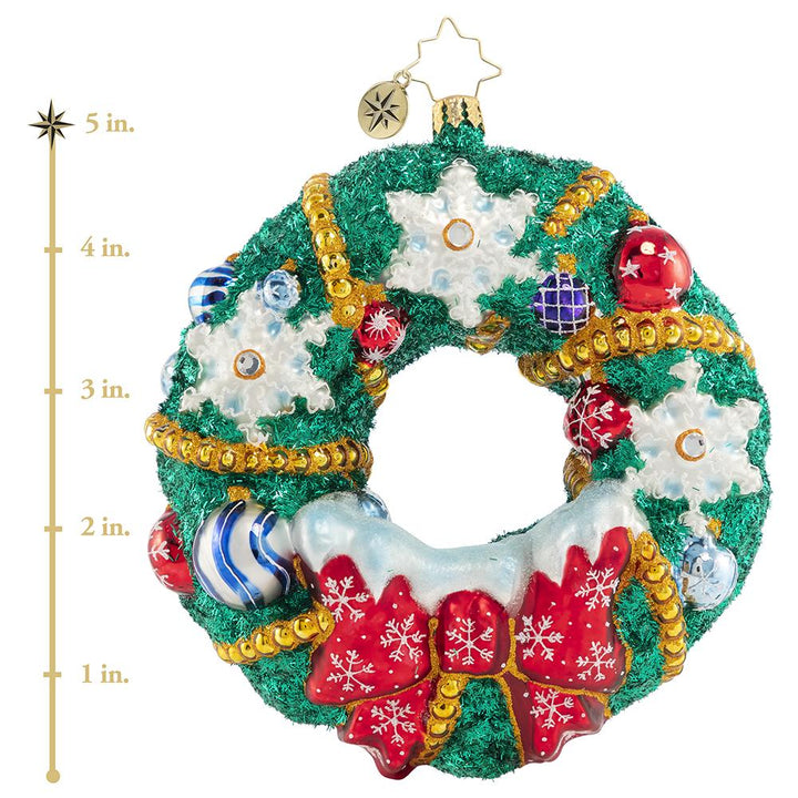 Ornament Description - Flurry of Flakes: A surprise flurry has passed through town, frosting everything in sight! This dazzling holiday wreath stands out despite all the snow! This photo shows the ornament is about 5 inches tall, 