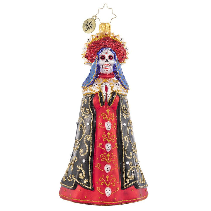 Front - Ornament Description - Lady of Shadows: Diosa mia! Crowned with a gilded flower halo and traditional threads of gold, La Catrina arrives to pay tribute at the altar.