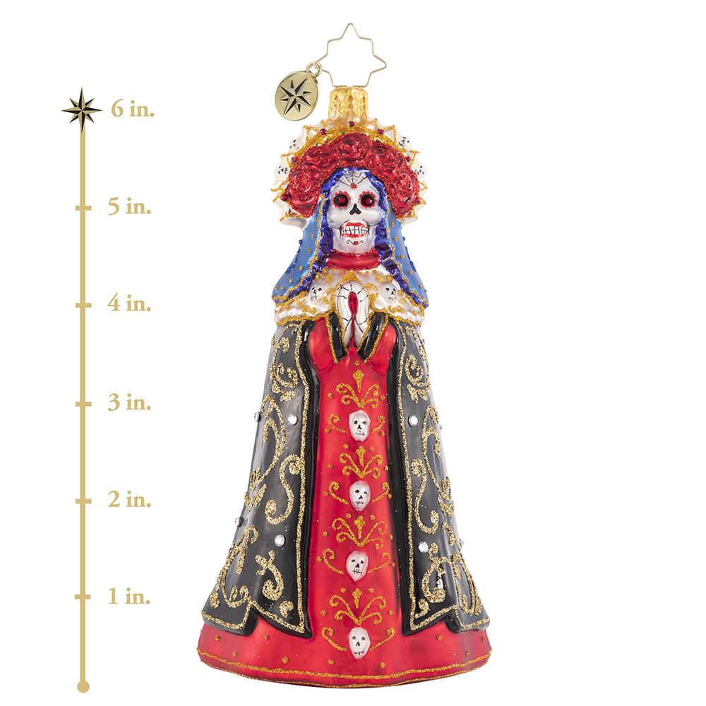 Ornament Description - Lady of Shadows: Diosa mia! Crowned with a gilded flower halo and traditional threads of gold, La Catrina arrives to pay tribute at the altar. This photo shows the ornament is about 6 inches tall. 