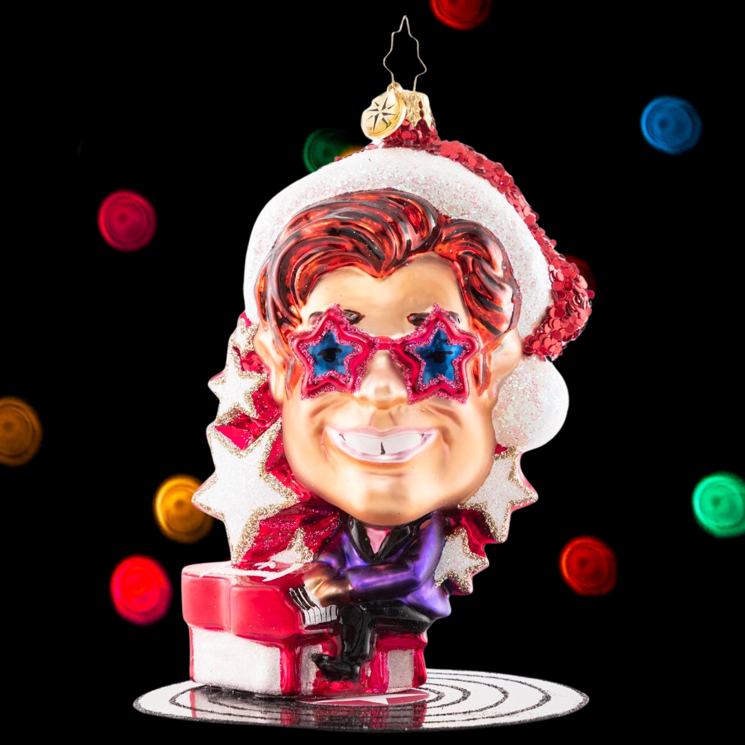 Ornament Description - Elton John's Center Stage: Donning a Santa hat and his signature shades, Elton John takes center stage for a holiday concert of some of his greatest hits. He is ready to Step Into Christmas and will have the crowd Crocodile Rockin' in no time!