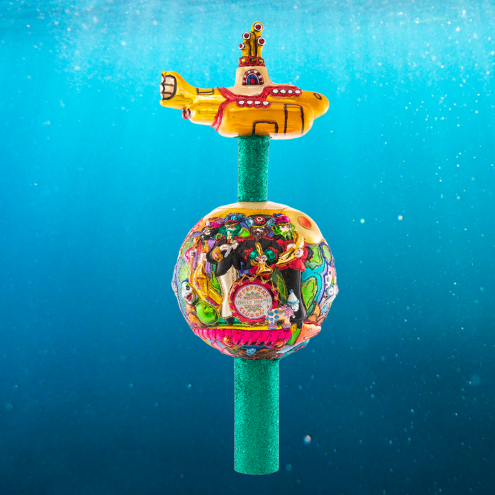 Finial Description - Beatles On Top: Topping charts AND trees this year, the boys are back from the USSR and are taking Christmas to new heights! Their signature yellow submarine crowns this fun-filled finial.