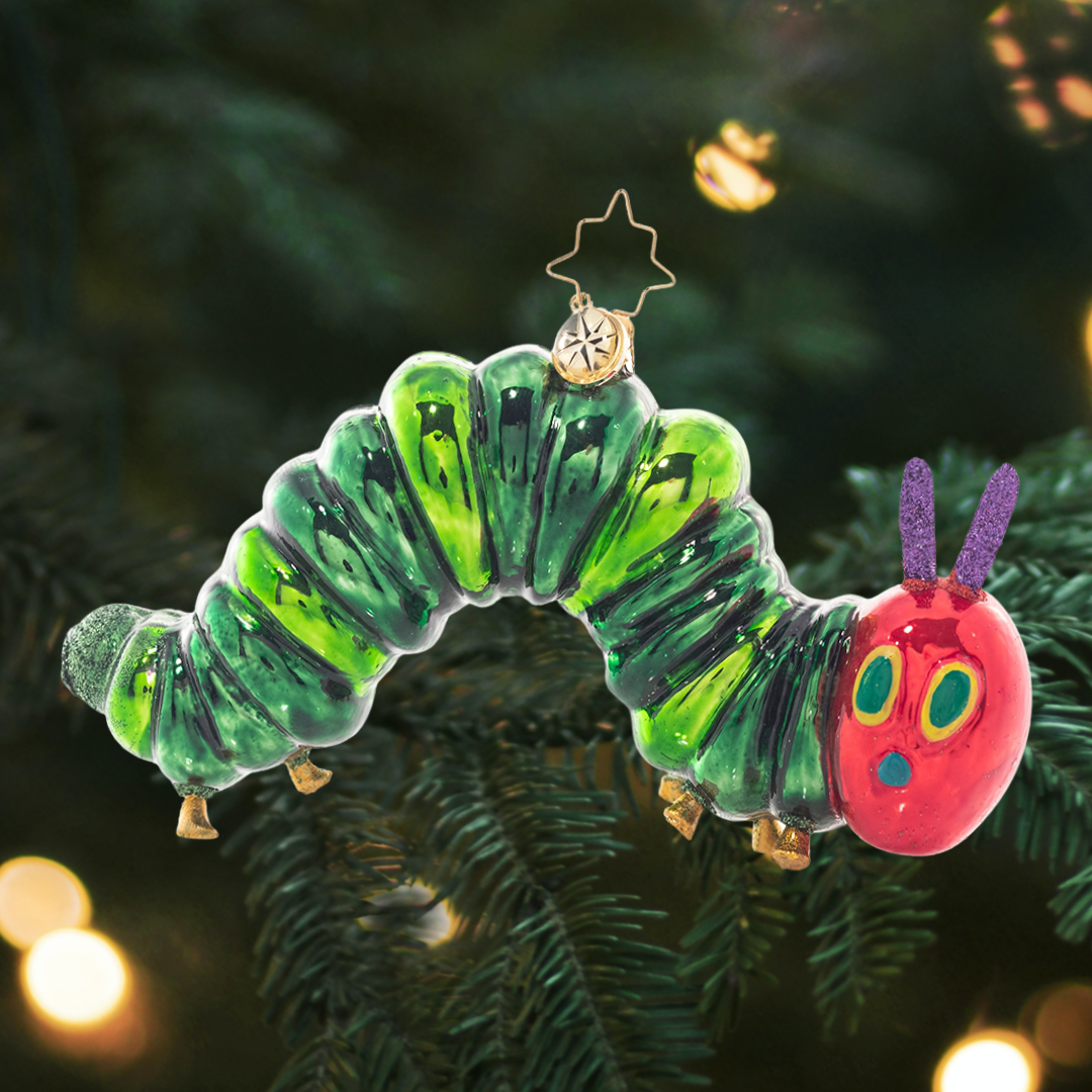 Ornament Description - It all started with one apple. The Very Hungry Caterpillar™ has inspired generations to discover and explore the world around them. Let this unique piece inspired by Eric Carle’s art spark your imagination and color your life! © 2021 Penguin Random House LLC. ERIC CARLE, THE VERY HUNGRY CATERPILLAR, THE WORLD OF ERIC CARLE logo,