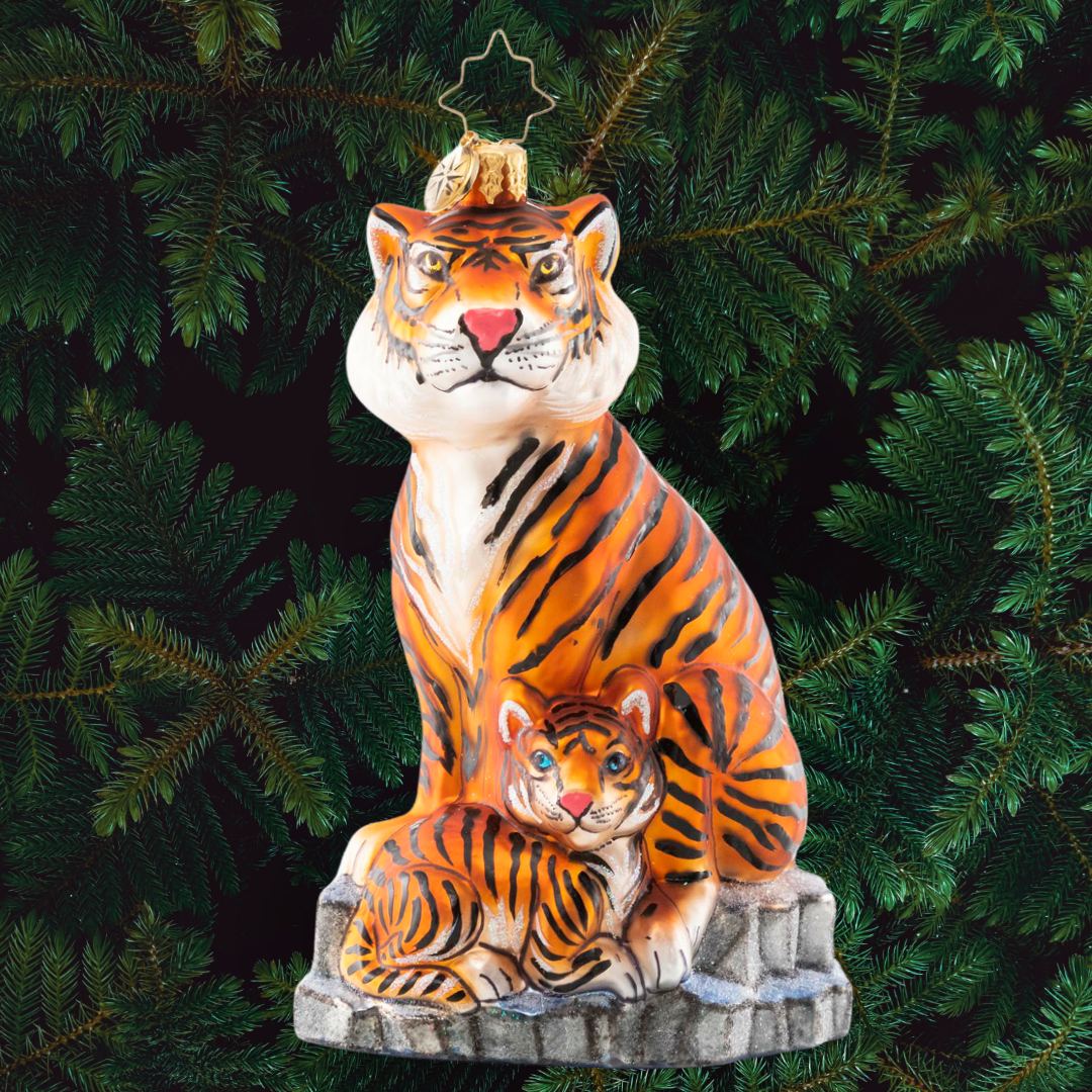 Ornament Description - The Coolest Cats: Tigers live in diverse habitatsâ€”from rain forests, grasslands, savannas and mangrove swampsâ€”but this pair of majestic tigers stun even in the winter snow. Tigers are under threat from human activities such as poaching, illegal trade, and habitat destruction. A percentage of the sales from this ornament will benefit global initiatives to combat tiger trafficking.