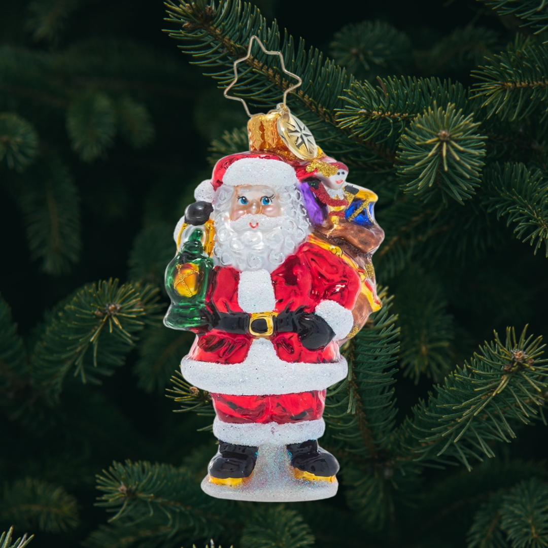 Ornament Description - Our Gallant Guide Gem: Light the way, Santa! Saint Nick presses on to deliver a sack full of Christmas treasure to every good girl and boy.