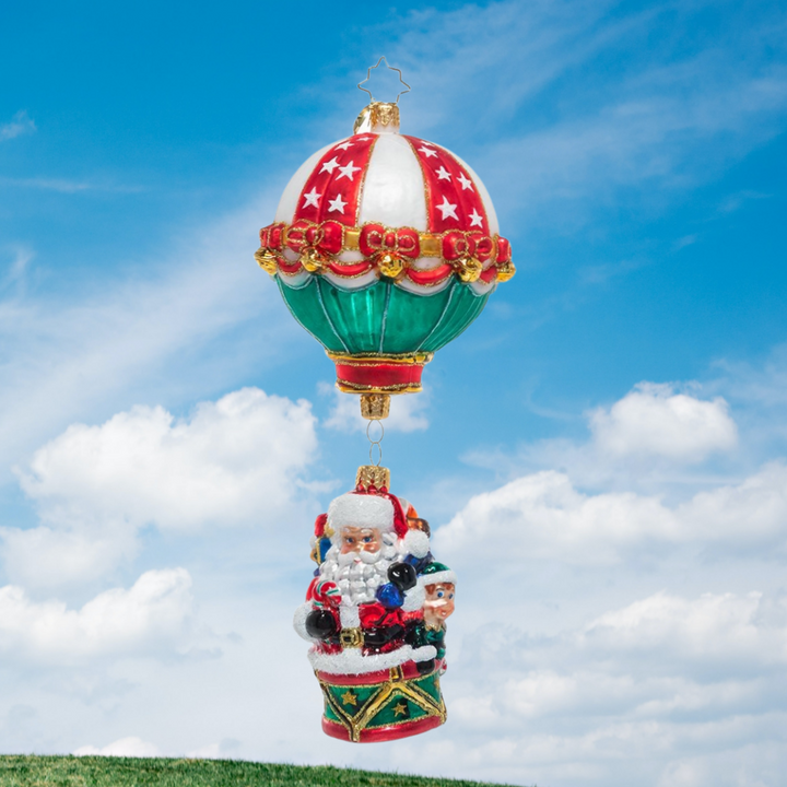 Ornament Description - Soaring to Holiday Heights: Up, up, and away! Santa has given his reindeer the day off, loading up the Claus hot air balloon to make all his special Christmas deliveries.