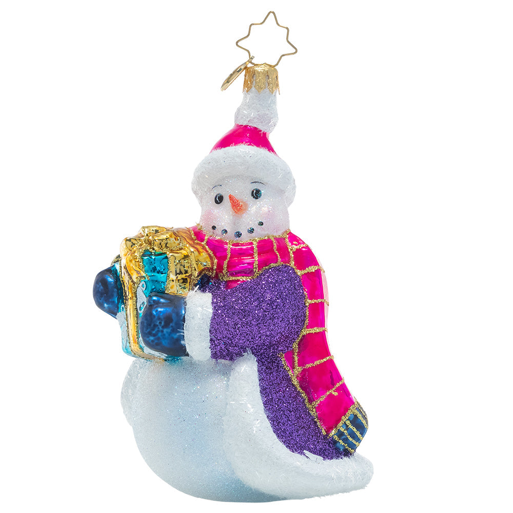 Front - Ornament Description - Smilin' And Stylin': This cheerful snowman has chosen some fabulous finery to guard him against the chill of winter as he travels to share a gift with a friend. He knows no ensemble is complete without a sparkly cloak and vibrant accessories. This snowman is certainly celebrating the holidays with his own unique flair!