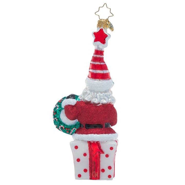 Back - Ornament Description - Vintage Vibrance: This cheery little Saint Nick wishes you a very Merry Christmas! Dressed in glittering ruby red and an extra-festive Santa cap, this jolly elf is ready to celebrate the season.