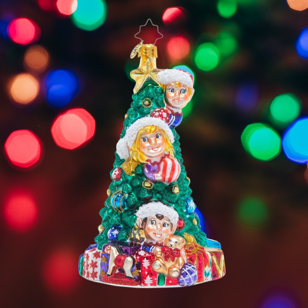 Ornament Description - Three Tree Trimmers: They don't call them Santa's helpers for nothing! These busy elves are hard at work making sure the North Pole workshop tree is trimmed perfectly to Santa's high standards.