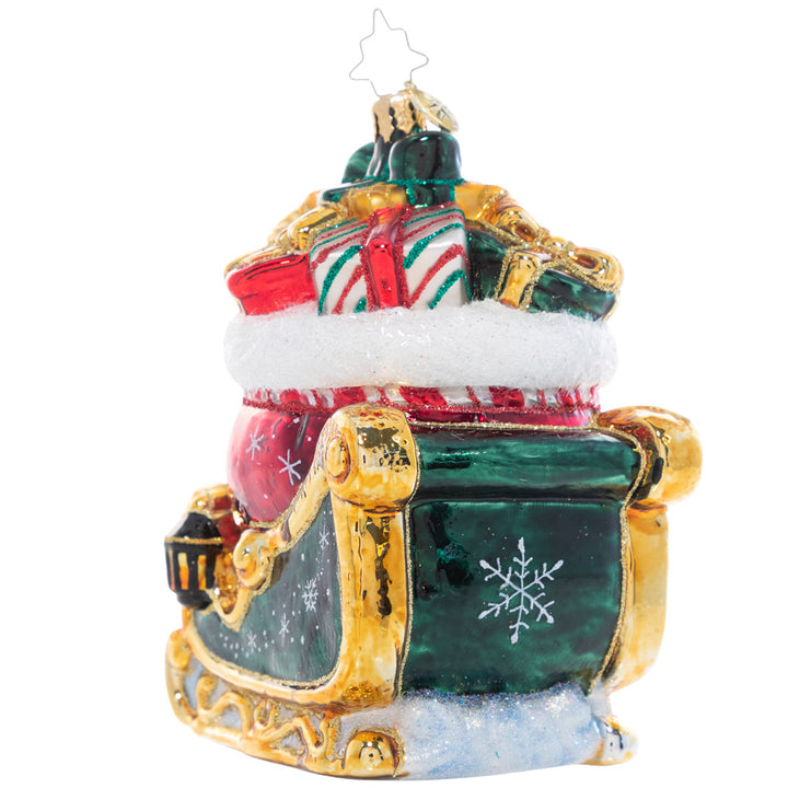 Back of Ornament - Ornament Description - Christmas Magic Sleight: Painted in the rich colors of the season and bursting with Christmas treasure, the sight of this gilded sleigh is enough to make a believer out of even the most stubborn skeptic!
