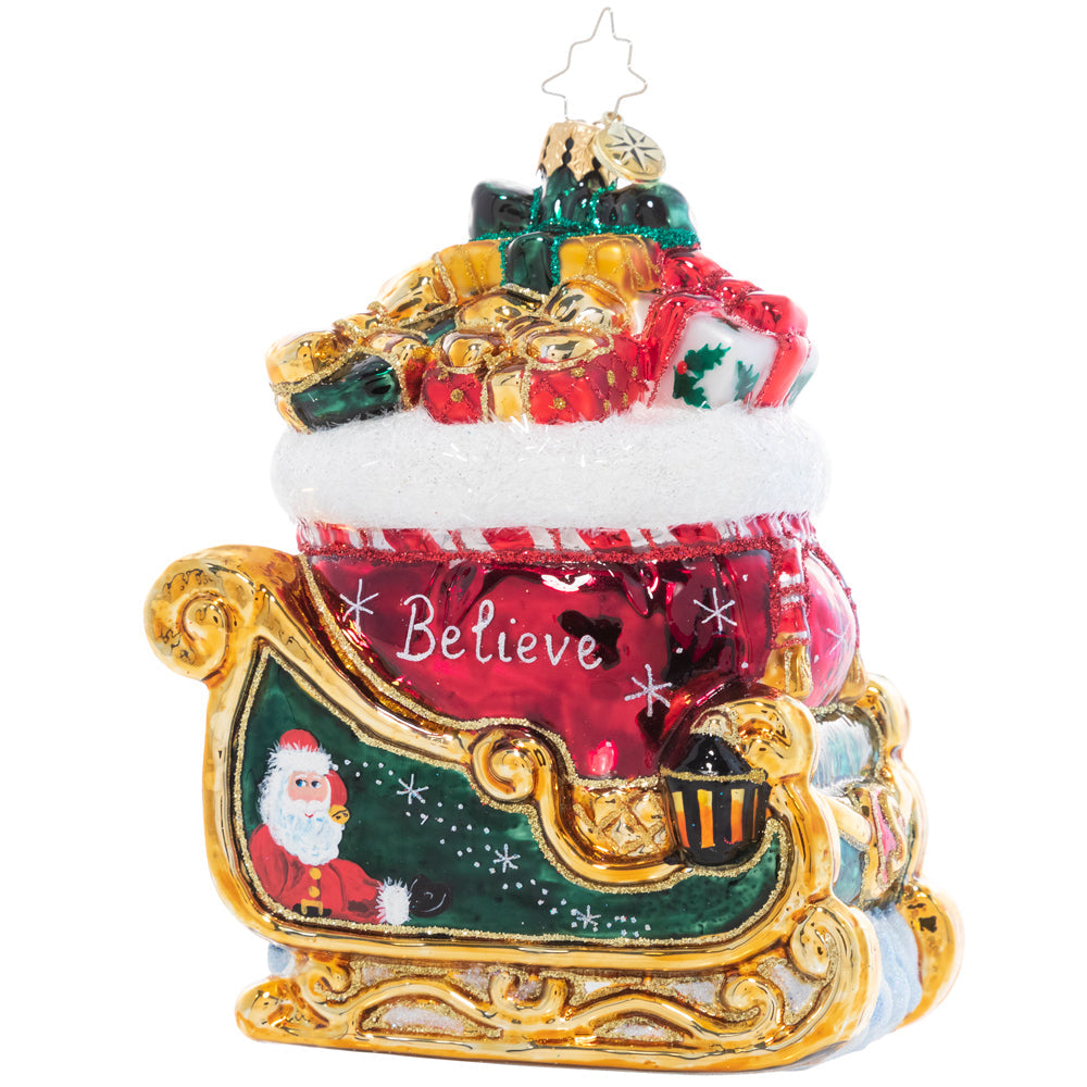 Front Side View - Ornament Description - Christmas Magic Sleight: Painted in the rich colors of the season and bursting with Christmas treasure, the sight of this gilded sleigh is enough to make a believer out of even the most stubborn skeptic!