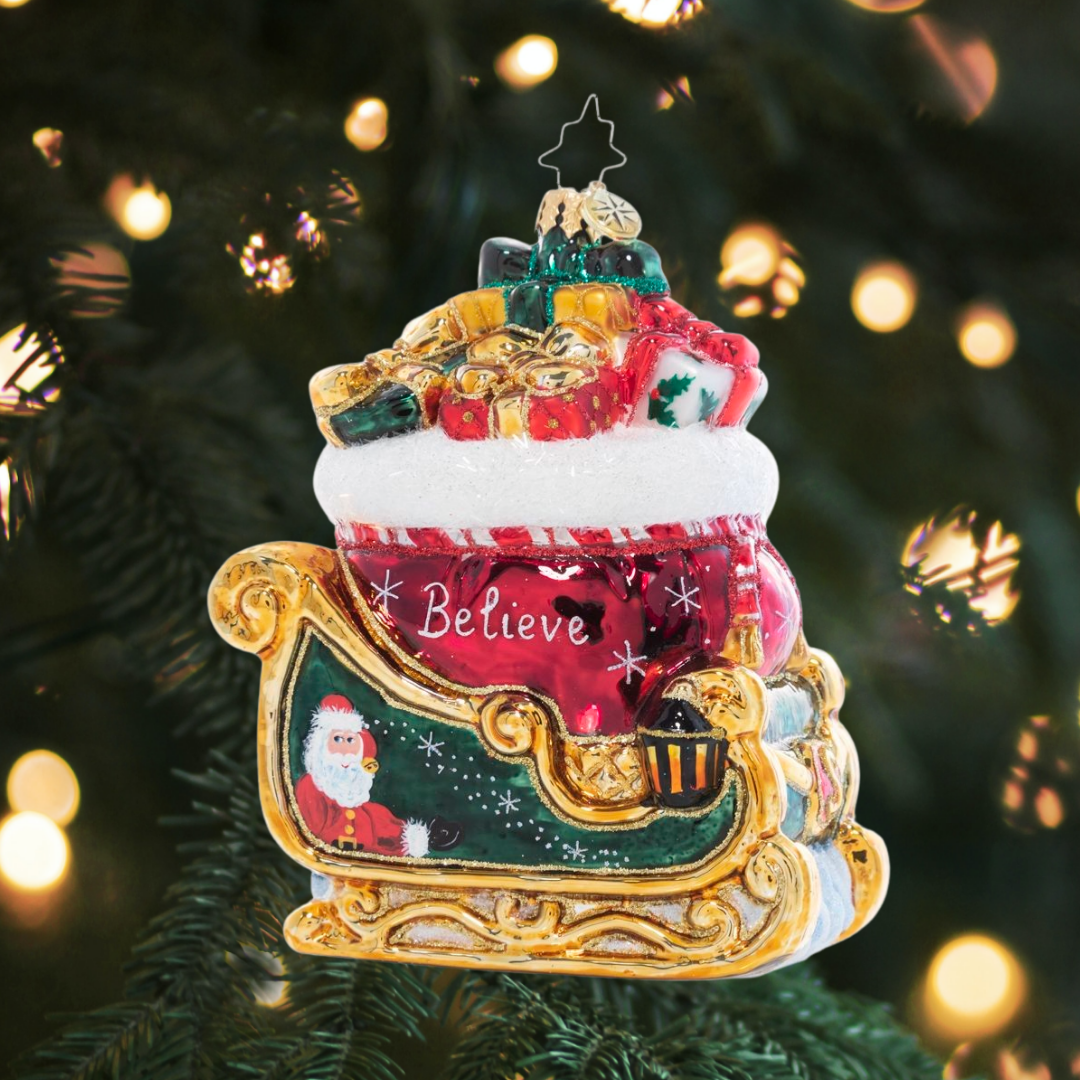 Ornament Description - Christmas Magic Sleight: Painted in the rich colors of the season and bursting with Christmas treasure, the sight of this gilded sleigh is enough to make a believer out of even the most stubborn skeptic!