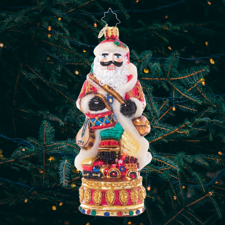 Ornament Description - Stately Conductor: Donning his finest fur-trimmed robe, this festive nutcracker is loaded up with everything he needs to celebrate the season. Bearing gifts, music, and even a miniature tree on his back, he's definitely "nuts" about Christmas!