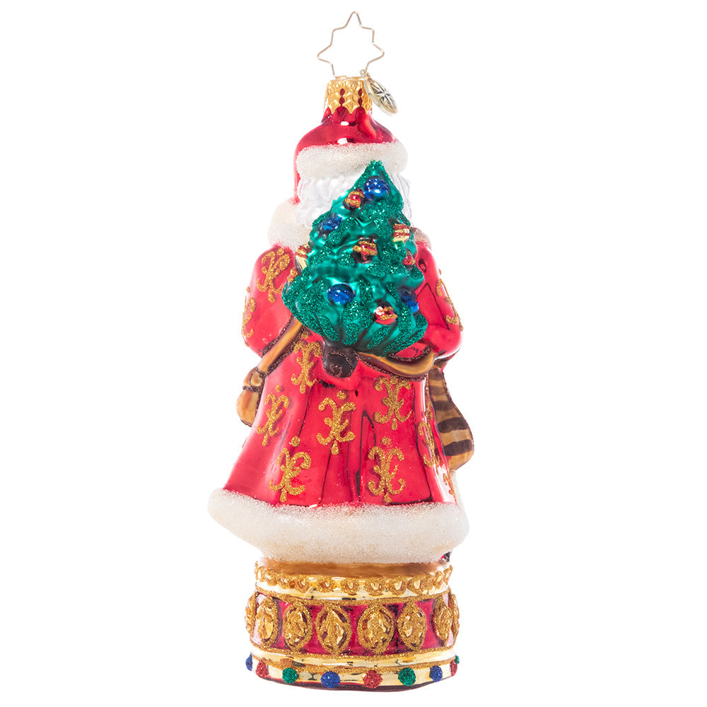 Back - Ornament Description - Stately Conductor: Donning his finest fur-trimmed robe, this festive nutcracker is loaded up with everything he needs to celebrate the season. Bearing gifts, music, and even a miniature tree on his back, he's definitely "nuts" about Christmas!