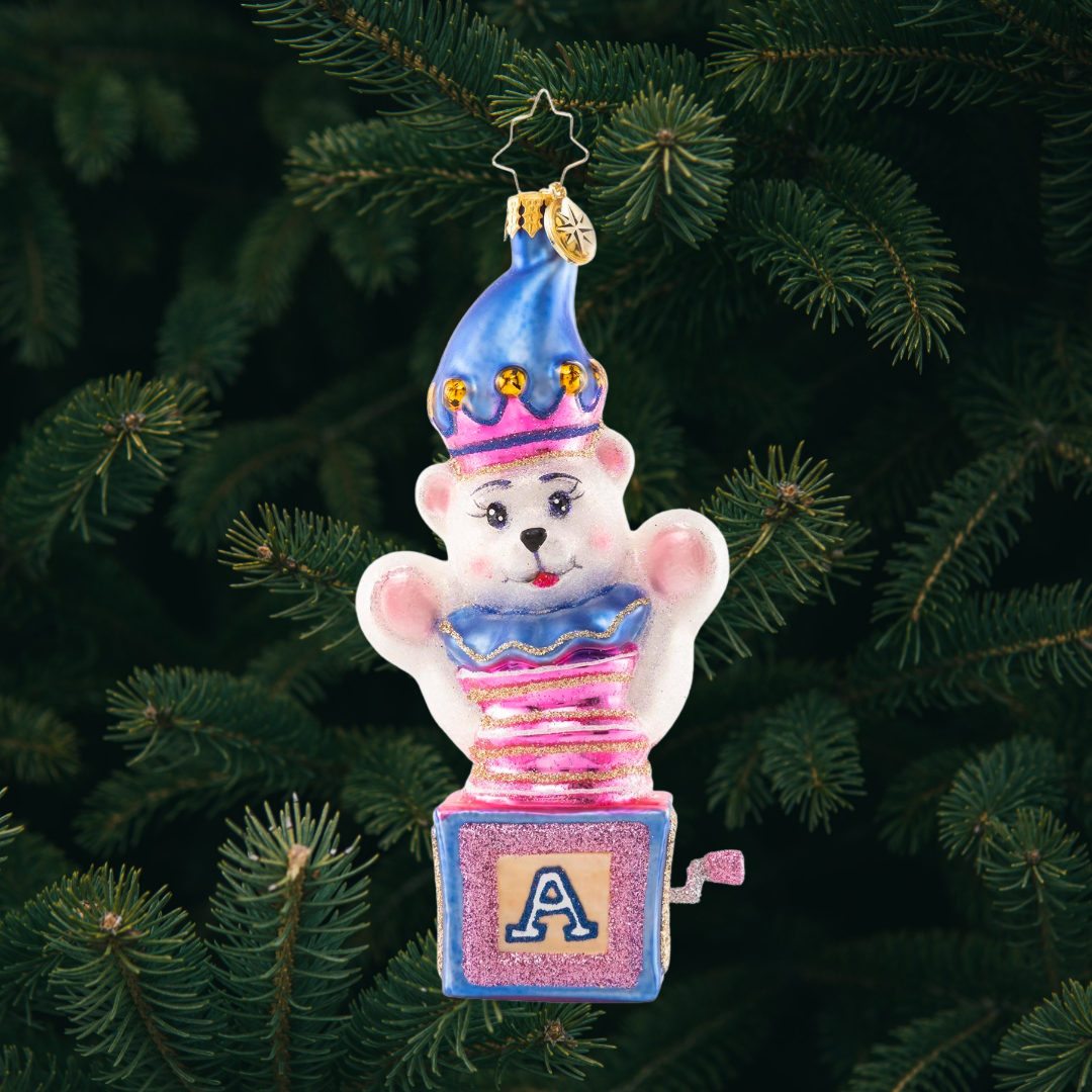 Ornament Description - Baby Bear Surprise: Peekaboo, baby bear! This adorable fuzzy friend pops out from his hiding place to bring a dose of Christmas cheer to one and all.