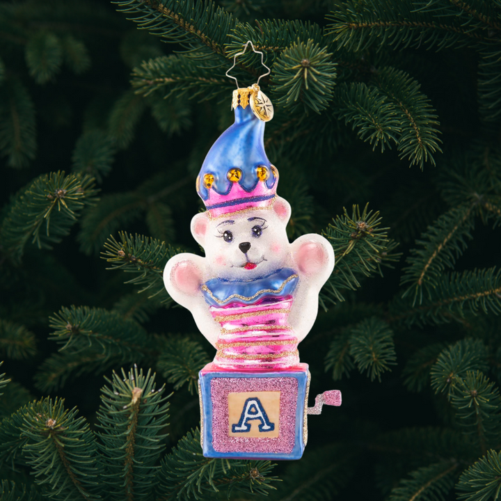 Ornament Description - Baby Bear Surprise: Peekaboo, baby bear! This adorable fuzzy friend pops out from his hiding place to bring a dose of Christmas cheer to one and all.