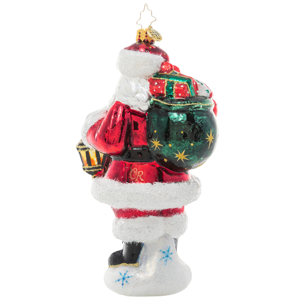 Back - Ornament Description - A Trusted Guide: Nothing stops Santa Claus, especially on Christmas Eve! No matter the weather, the glow from his trusty lantern lights his way through the snow on even the bleakest winter nights.