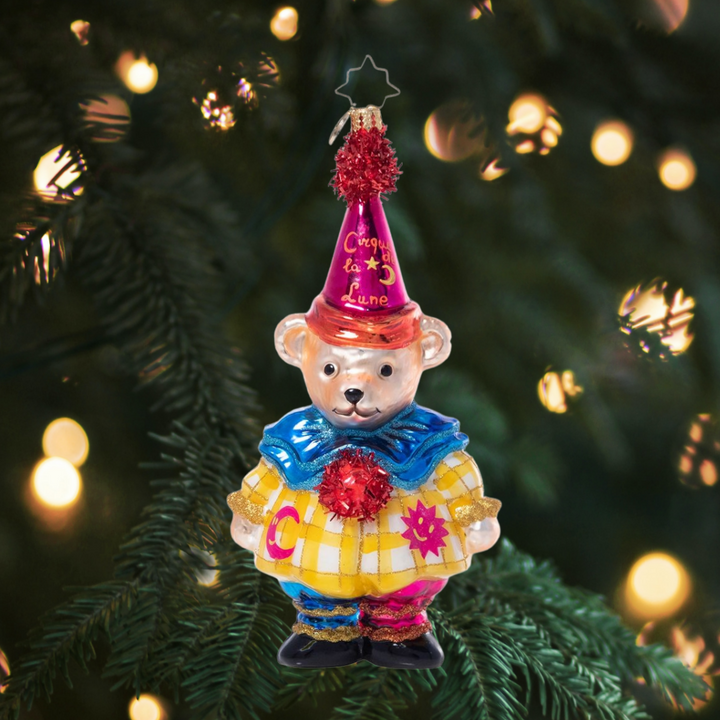 Ornament Description - Cirque De La Lune Muffy: Muffy Vanderbear is up to her adventures again, this time running off to join the circus! Wearing an adorable clown costume for the Cirque de Lune, she looks ready for the big show!