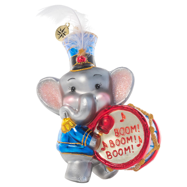 Ornament Description - Keep Good Time: Parum-pum-pum-pum – This adorable elephant drummer boy makes sure the beat goes on! He's looking dapper in his special holiday uniform and feathered cap.