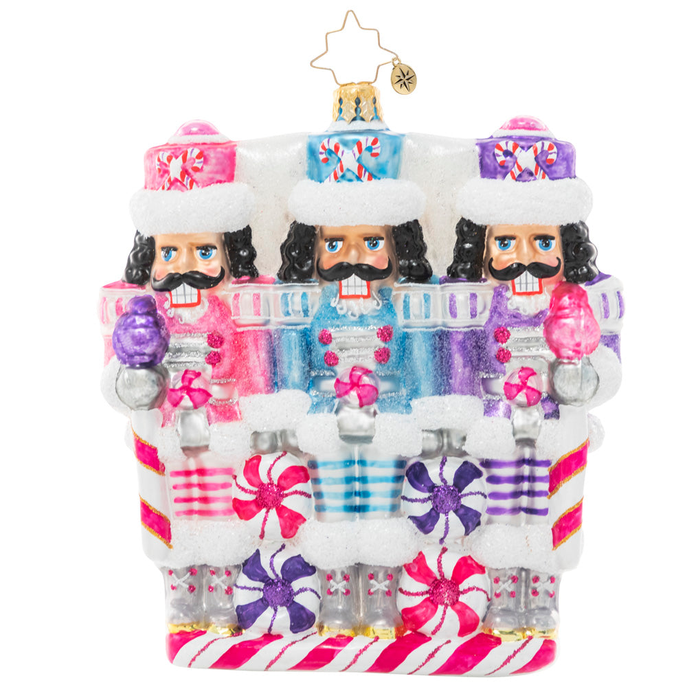 Front - Ornament Description - The Sweetest Trio: A trio of nutcrackers smile dutifully from their posts, dressed in uniforms of wintry pastels. Someone's got to guard the North Pole candy stash, and three heads are better than one!