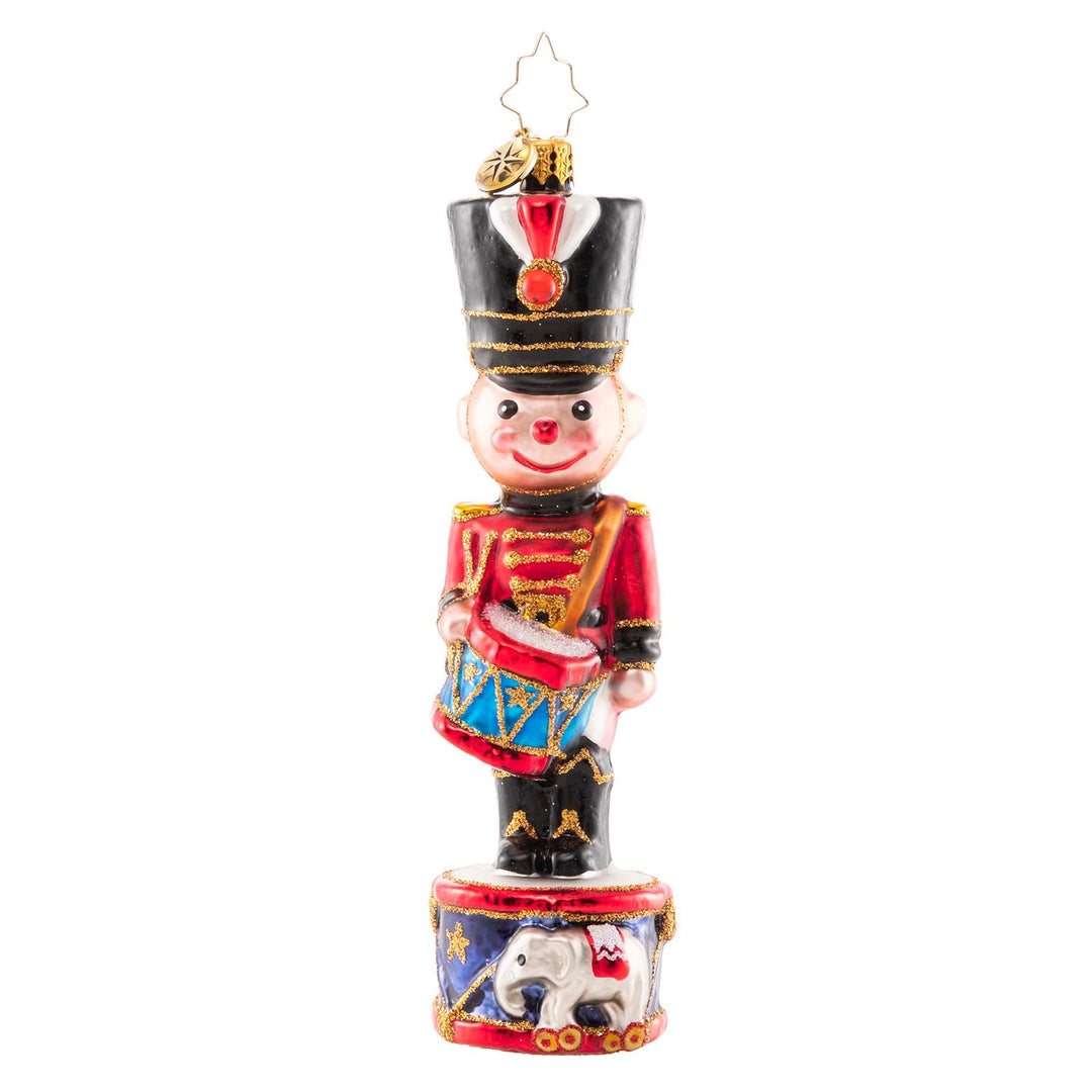 Front - Ornament Description - Cheerful Toy Solider: A-ten-hut! Dressed in a holiday red coat and shiny black boots, this smiling soldier grins from his post atop a Christmas drum.