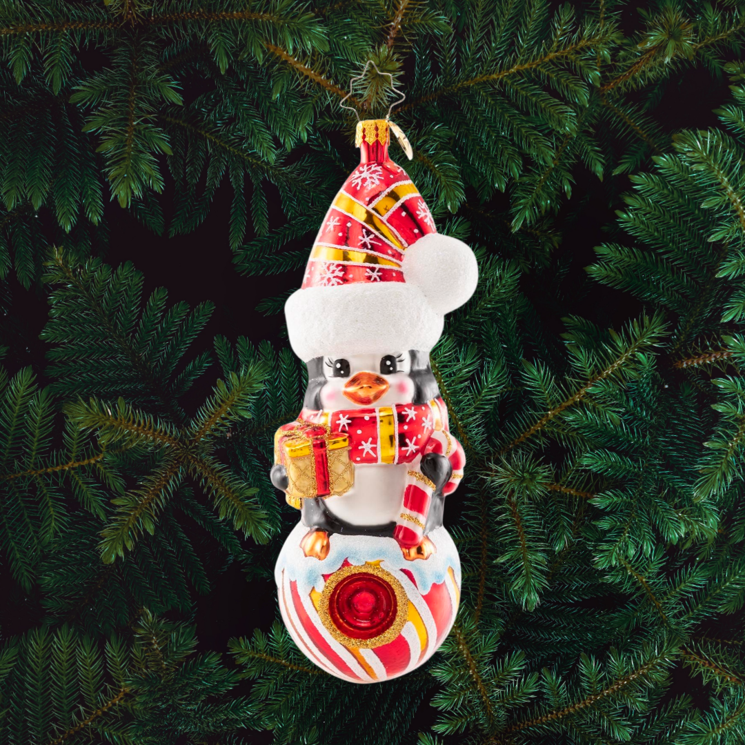 Ornament Description - Play it Cool: This tiny penguin friend smiles from her perch atop a peppermint candy ball in a swirly Santa hat and matching scarf. She's looking minty, merry and marvelous!