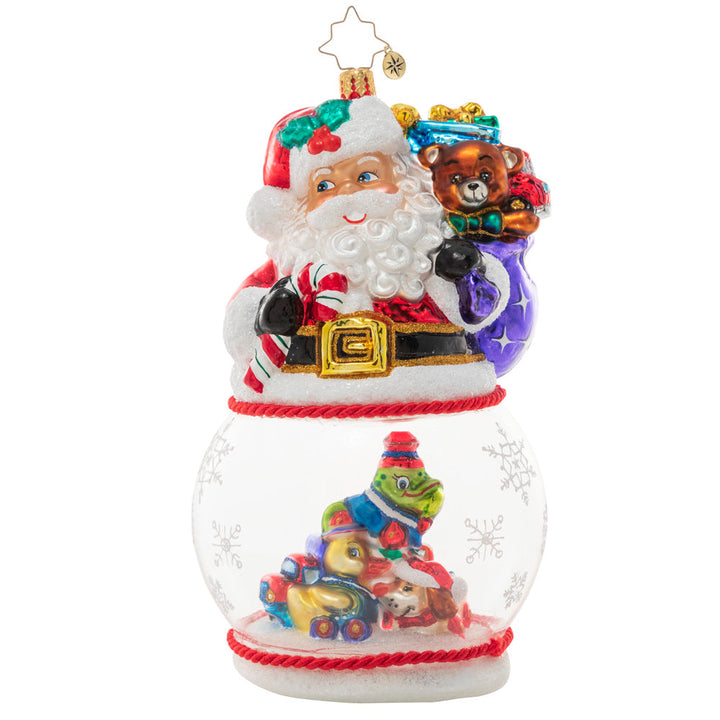 Ornament Description - Santa's Magic Snow Globe: It's a wonderful time of the year for Santa Claus, who's looking even more jolly than usual! With his sack of surprises slung over his shoulder, he smiles over a pile of Christmas toys inside a swirling snow globe.
