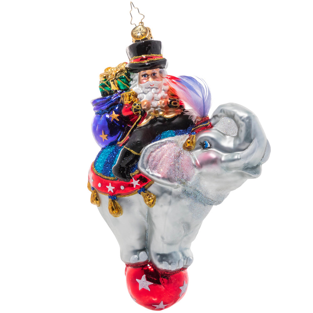 Front - Ornament Description - Ringmaster Claus: Step right up! Santa's no stranger to running the show so it only makes sense that he'd be master of his own circus! He smiles from atop a talented elephant performer on the night of the big show.