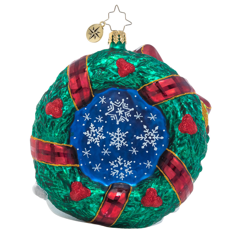 Ornaments - Description: A festive tartan bow is the perfect accent for this classic Christmas wreath ornament that features swirling snowflakes, bright holly berries and even the big man himself, Santa Claus! He's speeding through in his Christmas pickup with a truckload of last-minute deliveries.