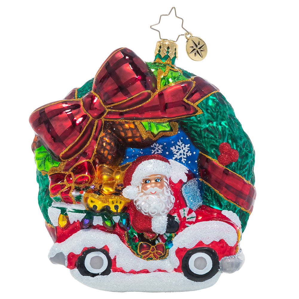 Front - Ornament Description - Rustic Christmas Wreath: A festive tartan bow is the perfect accent for this classic Christmas wreath ornament that features swirling snowflakes, bright holly berries and even the big man himself, Santa Claus! He's speeding through in his Christmas pickup with a truckload of last-minute deliveries.