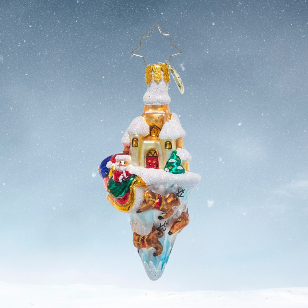 Ornament Description - Paradise On Ice Gem: North Pole on ice! This detailed little ornament shows off all of the best parts of the North Pole; Saint Nick and his sleigh, flying reindeer, the warm glow of Santa's workshop, and of course lots of snowy scenery.