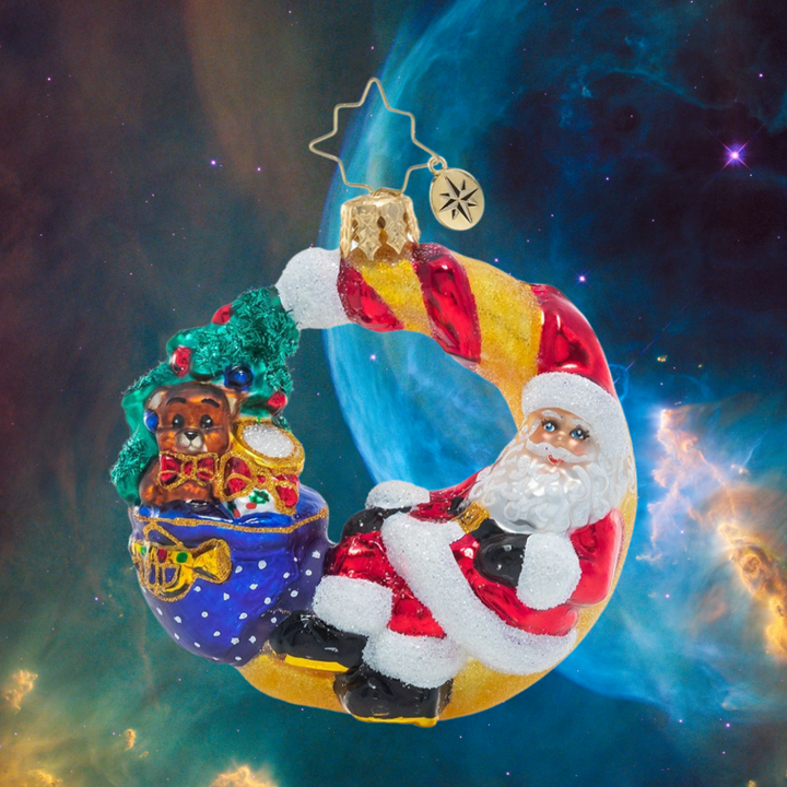 Ornament Description - Over the Moon For Christmas Gem: Even Santa needs a break sometimes! He sets down his sack to lounge against a crescent moon to look down on the peaceful sleeping world and reflect on his hard work so far.