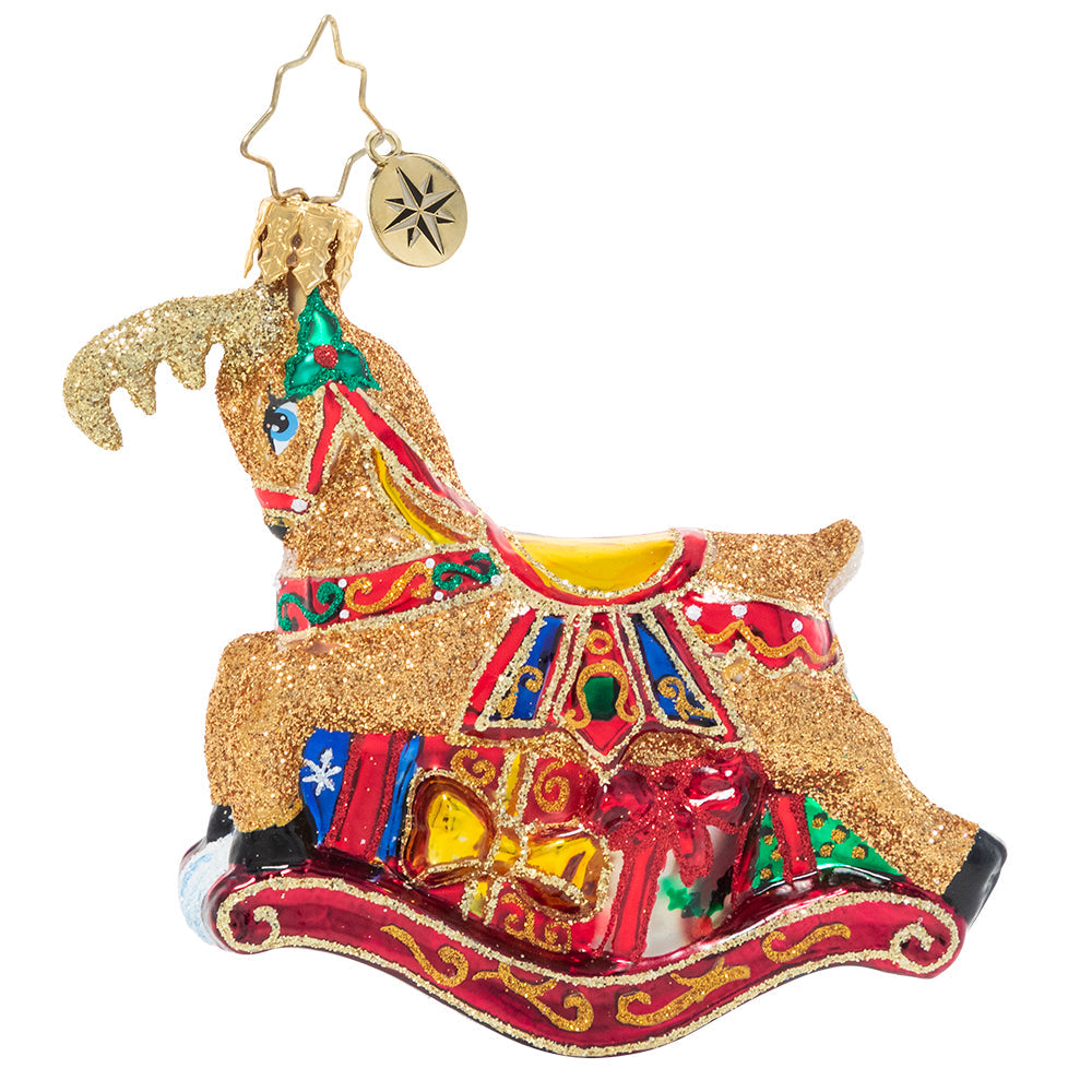 Ornament Description - The Buck Rocks Here Gem: Who's that gliding through the snow? A holiday rocking-deer, that's who! This delightful little fellow prances atop a pile of pretty presents, ready to leap into your holiday home.