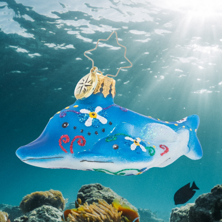 Ornament Description - Swimming Through Florals Gem: It may be the middle of winter, but this friendly dolphin pair is sure to remind you of warmer days ahead! Gaze at their bright colors and tropical florals and reminisce about your favorite vacation memories!