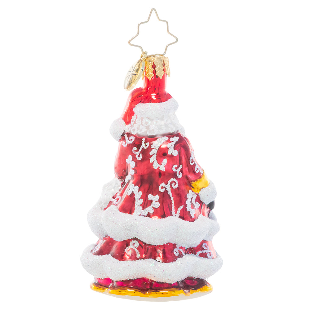 Back - Ornament Description - An En-deer-ing St. Nick Gem: Santa Claus looks extra festive in his ruby red robes decorated with glittering white flourishes. He carries a gleaming golden staff to help light his way through the cold winter's night.