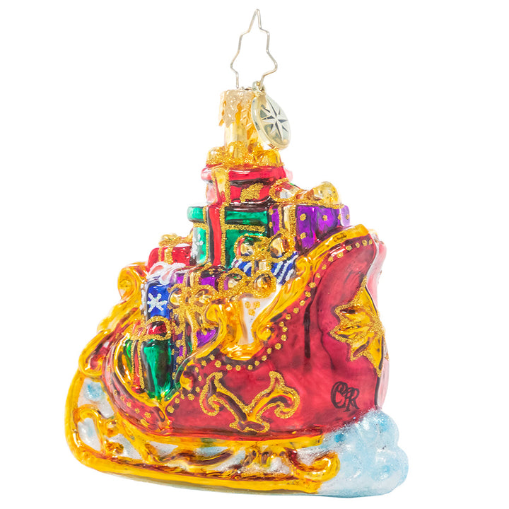 Back - Ornament Description - Regally Radiant Sleigh Gem: Santa's sleigh is packed to the brim with Christmas gifts for good girls and boys. Here's hoping we're on the nice list!