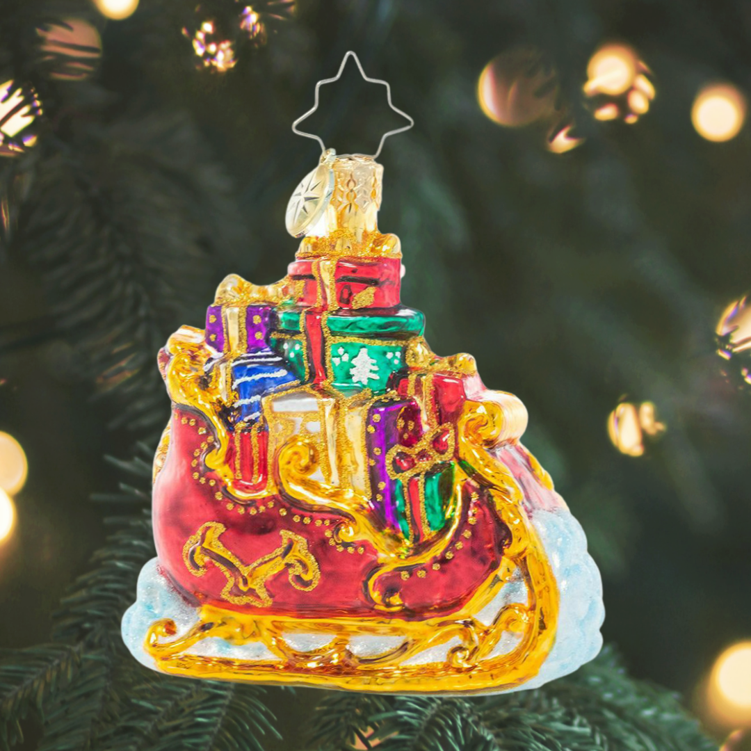Ornament Description - Regally Radiant Sleigh Gem: Santa's sleigh is packed to the brim with Christmas gifts for good girls and boys. Here's hoping we're on the nice list!