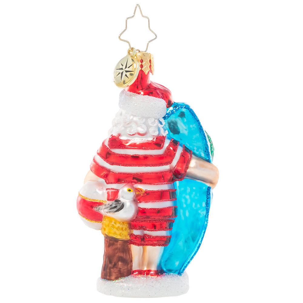 Back - Ornament Description - Wishing For Waves Santa Gem: Ho-ho-hang ten! Santa looks ready to catch a wave as he waits for the surf report holding his bright blue surfboard.