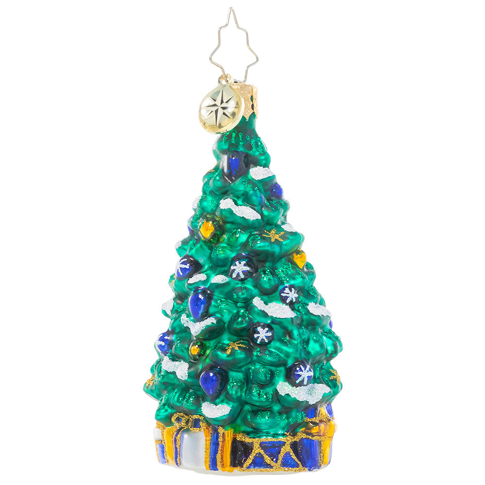 Back - Ornament Description - Shimmering In Sapphire Gem: This stylish tree is trimmed and ready for the big night, eschewing traditional red for a more subdued blue, white and gold. Presents tucked beneath the branches match the calm tones of the ornaments perfectly, completing the sophisticated look!