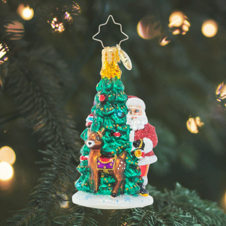 Ornament Description - Two Talented Tree Trimmers: Time to deck the halls! Enlisting the help of his reindeer companion, Santa trims the North Pole Christmas tree in his favorite heirloom ornaments. Time to deck the halls! Enlisting the help of his reindeer companion, Santa trims the North Pole Christmas tree in his favorite heirloom ornaments.