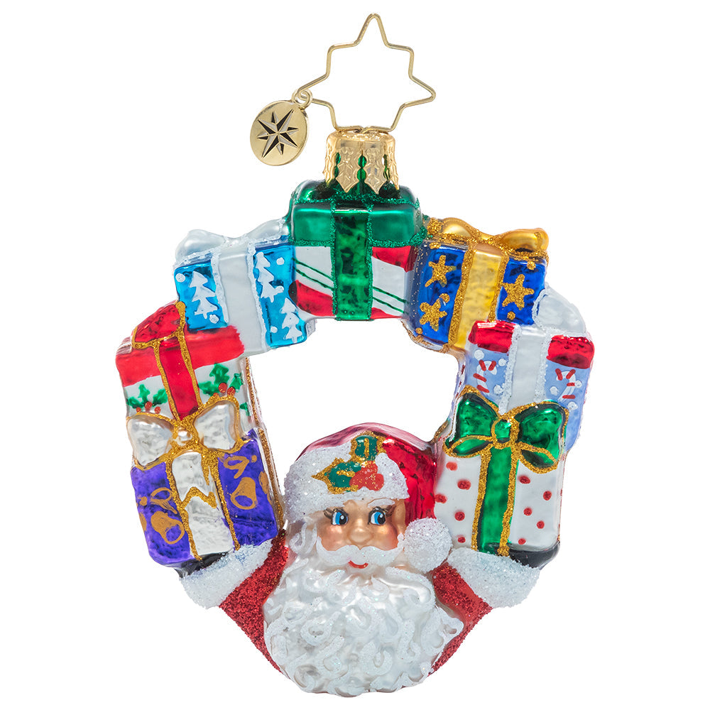 Front - Ornament Description - Ring of Delights Gem: Now he's just showing off! Santa expertly balances his Christmas bounty in an impressive arc on his way to deliver his latest load of surprises.
