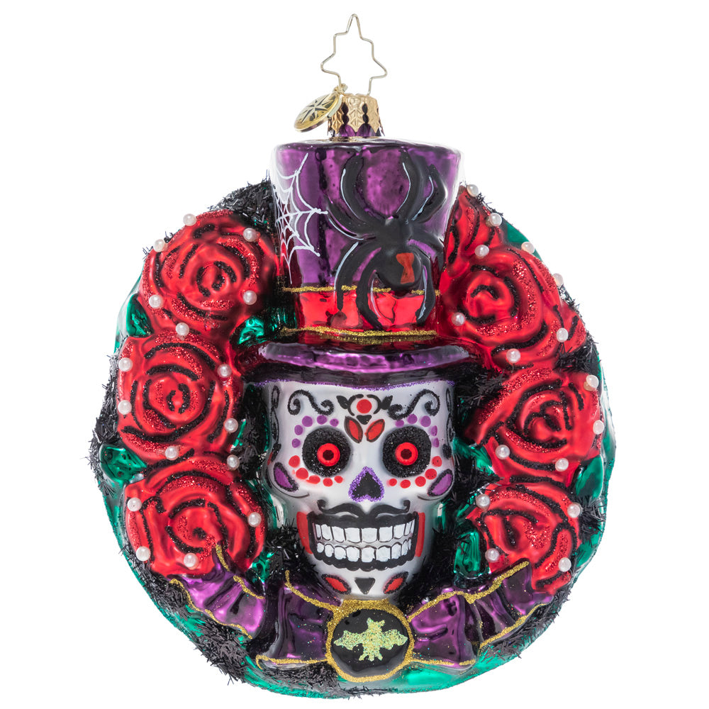 Front - Ornament Description - Spooky Skull Wreath: Celebrate spooky season with this gothic-inspired calavera wreath. A ring of blood-red roses encircles a trio of black bats and a grimacing sugar skull – all things that make Halloween so frightfully fun!