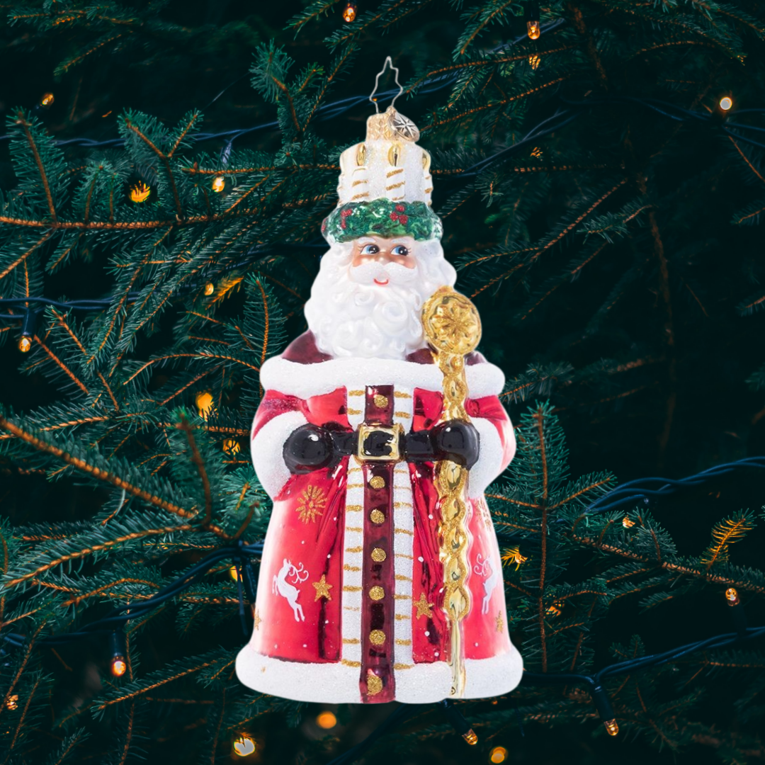 Ornament Description - God Jul Santa: This Santa wears a crown of candles and a shiny red robe adorned with a delicate white pattern reminiscent of traditional Nordic Christmas motifs, paying homage to the Scandinavian feast of Santa Lucia.