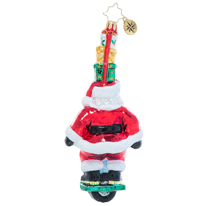 Back - Ornament Description - One Wheelin' Santa: Proving you're never too old to learn new tricks, Santa expertly rides a single wheel while balancing a stack of gifts on his head. Is there nothing this guy can't do?